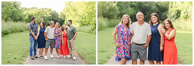 Multi-generational family of six, including two husbands, laughing together on a wooded trail in the Midwest; mother, father, and two adult daughters pose for a golden hour family portrait on the trail.
