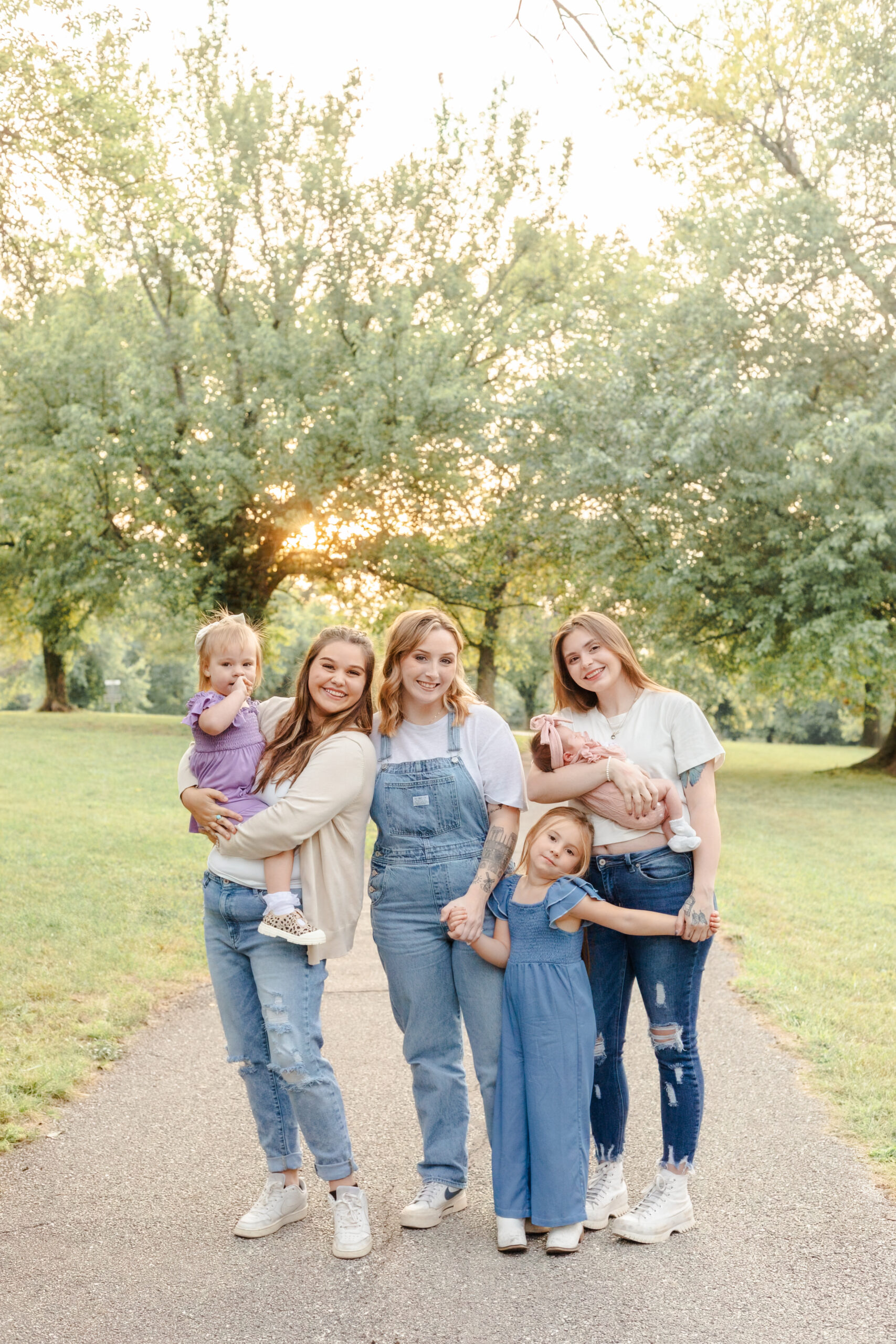 group of sisters with their children, all smiling and looking at the camera