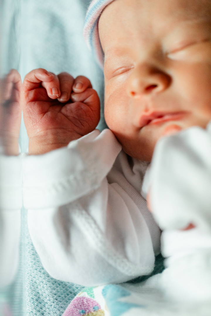 first 48 photos in emporia kansas. Sleeping newborn boy resting with his hand by his face